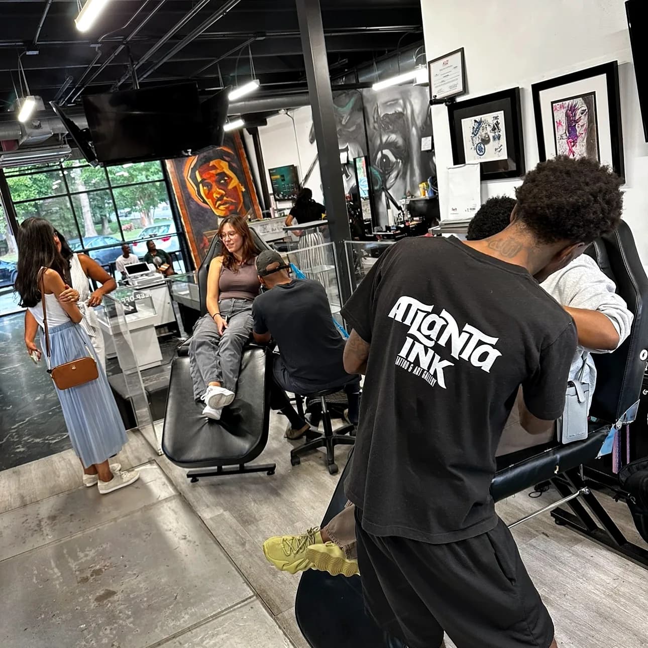 Tattoo artist working at a station inside the ATLANTA INK studio